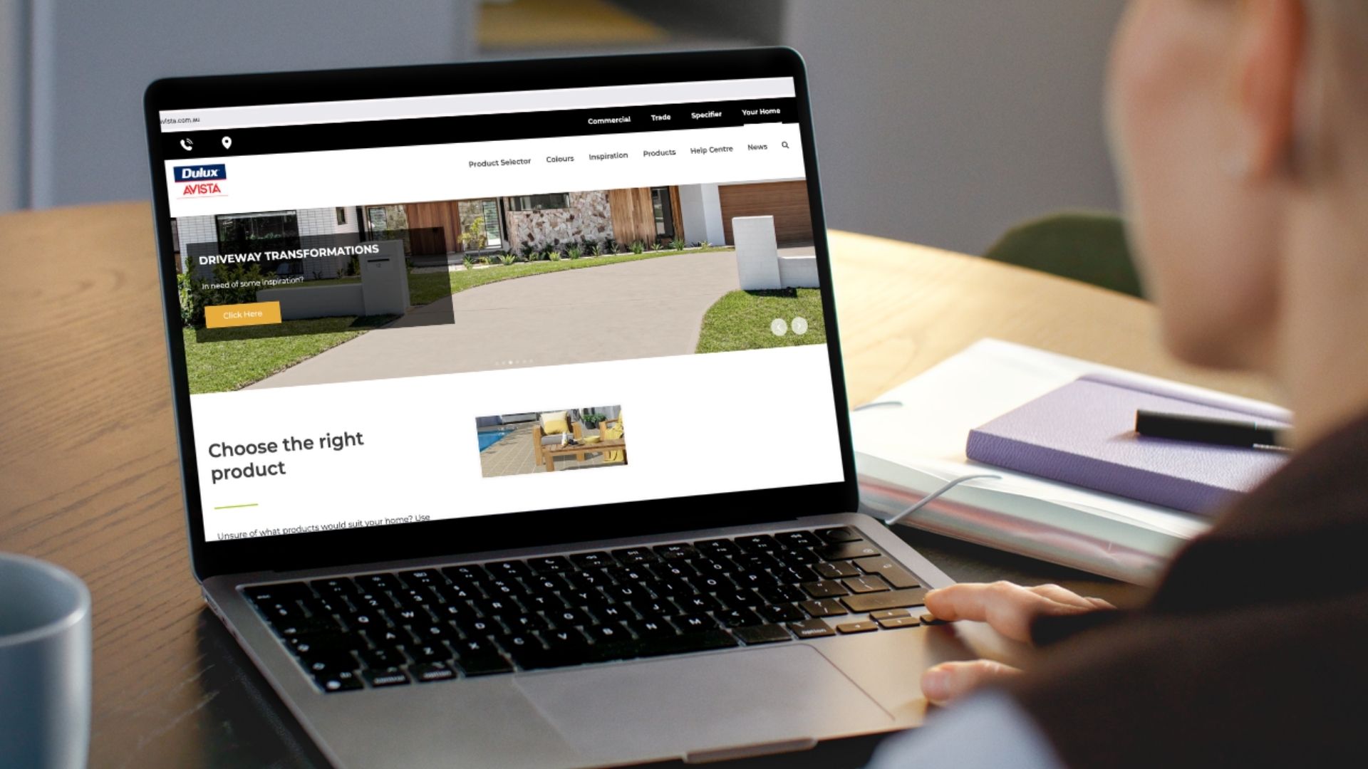 Man viewing Dulux Avista website on computer screen.