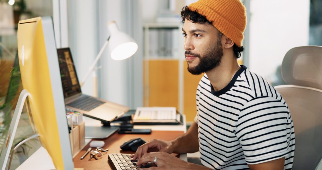 Young man looking at computer searching